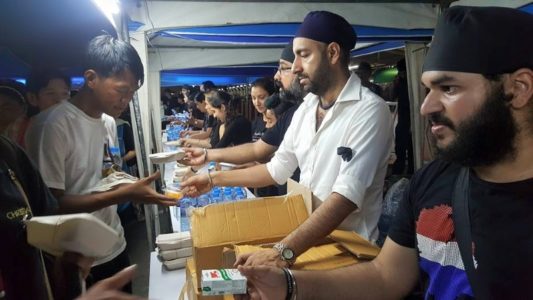 Sikhs distributing food at Bangkok train station to citizens converging at Bangkok to pay respects to the late King Bhumibol